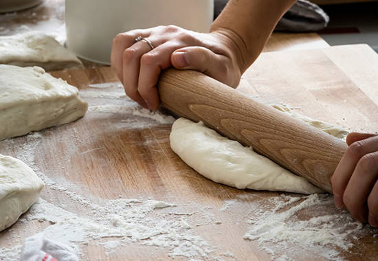 Baker Kneading Dough Kitchen Closeup
